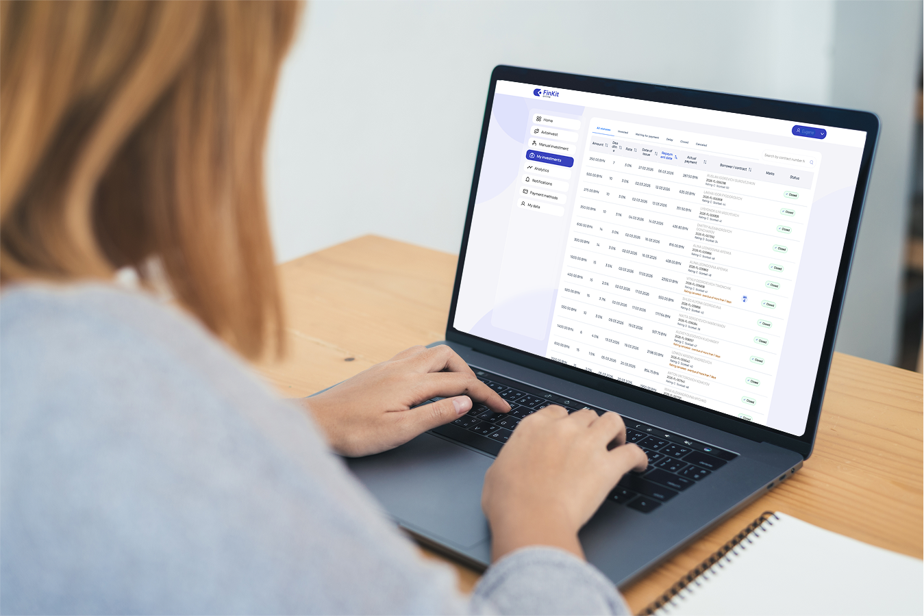 FinKit P2P investment platform shown on a laptop